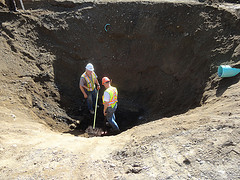 Construction Workers Digging A Hole