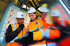 Industrial Workers Looking At Manual